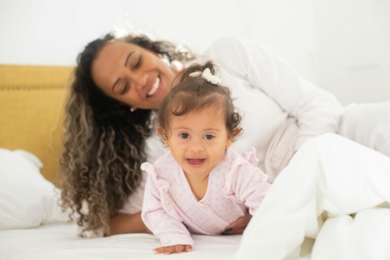 photo of a mother waking up with her daughter on the bed